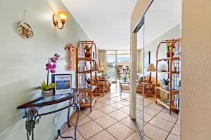 a living room with a table and chairs in a room at Kihei Kai Nani 368 in Kihei