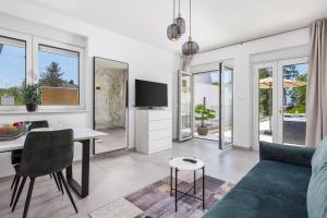 a living room with a couch and a table at VILLA MAR - LUXURY APARTMENTS with pool and Deluxe apartment with hot tub in Selce, 20 meters from the beach in Selce