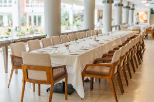a long dining room with a long table and chairs at Los Tajibos, Santa Cruz de la Sierra, a Tribute Portfolio Hotel in Santa Cruz de la Sierra