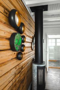 Habitación con pared de madera y estufa de leña. en Lofoten Villa, en Reine