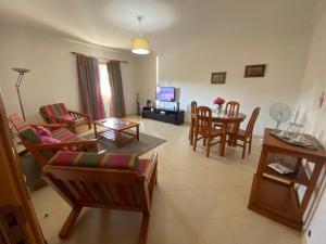 a living room with a couch and a table at Nice apartment near Faro's airport in Faro