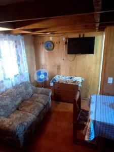 a bedroom with a bed and a flat screen tv at Apartamentos Cadiz -Valdivia in Valdivia