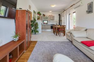 a living room with a couch and a table at Apartments Anica - Vlašići Island Pag in Vlašići