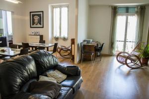 a living room with a leather couch and a table at B&B 55 Alghero in Alghero