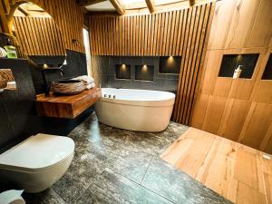 a bathroom with a tub and a toilet in it at Kairos Deluxe in Melgar +20 photos