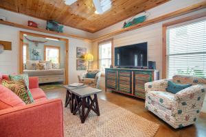 a living room with two couches and a flat screen tv at The RITZ Tarpon- VW 83 in Port Aransas