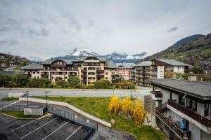 a group of apartment buildings with mountains in the background at A magnificent apartment in the beautiful French mountains in Saint-Gervais-les-Bains