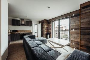 a living room with a couch and a table at A magnificent apartment in the beautiful French mountains in Saint-Gervais-les-Bains