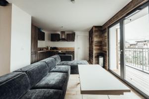 a living room with a couch and a table at A magnificent apartment in the beautiful French mountains in Saint-Gervais-les-Bains