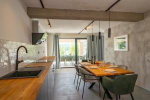 a kitchen and dining room with a table and chairs at Seaside luxury villa with a swimming pool Sumartin, Brac - 5639 in Sumartin