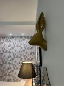 a bronze bird head on a wall next to a lamp at Warsaw Dream w sercu miasta - FREE PARKING - nowy most in Warsaw