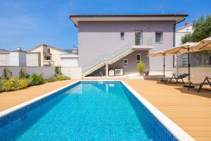 a swimming pool in front of a house at VILLA MAR - LUXURY APARTMENTS with pool and hot tub in Selce, 20 meters from the beach, Boat tours option in Selce