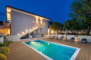 a swimming pool in the backyard of a house at VILLA MAR - LUXURY APARTMENTS with pool and Deluxe apartment with hot tub in Selce, 20 meters from the beach in Selce