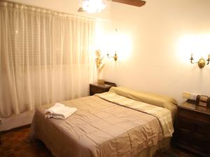 a bedroom with a bed with a towel on it at Micuman Habitaciones en microcentro con baño privado in San Miguel de Tucumán