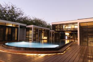 a house with a swimming pool on a wooden deck at 99 Surf Lodge in El Limón