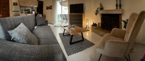 a living room with a couch and a fireplace at Gardenia apartment in Preveza