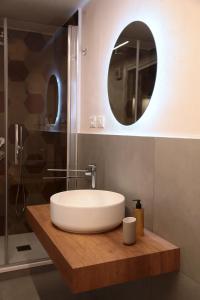 a bathroom with a white sink and a mirror at Alle Absidi della Cattedrale in Palermo