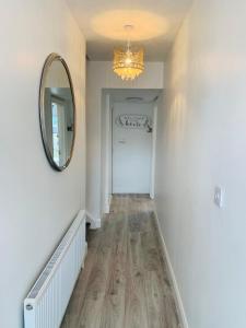a hallway with a mirror and a white door at Station House in Ballina