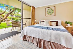 una camera da letto con un letto e una porta scorrevole in vetro di Napili Shores D132 a Kahana Altre 29 foto