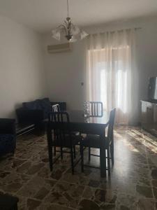 einen Esstisch und Stühle im Wohnzimmer in der Unterkunft Appartamento Peschici in Peschici
