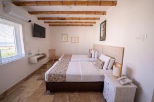 Cama ou camas em um quarto em Atoq Paracas Reserva