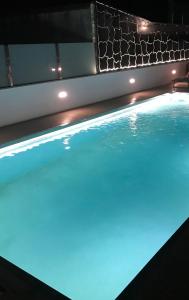 a swimming pool with blue lights on it at Pisos viajer@s in O Grove