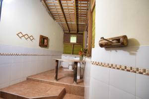 a bathroom with a sink and a toilet in a room at Strawberry Fields Together in Robins Bay