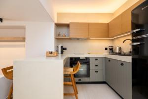 a kitchen with a counter and a stove top oven at SunSal Luxury Studios - Sky in Naousa