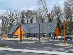 a large orange and blue building with a parking lot at Luxury Suite with water view - 2 mini bedrooms in Greenwich