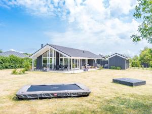 a house with a trampoline in the yard at Holiday home Tarm XLIV in Tarm