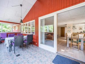 a living room with a table and chairs and a dining room at Holiday home Blåvand CCXXXVIII in Blåvand