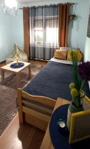 a bedroom with a large bed and a table at Serbian home Smederevo in Smederevo
