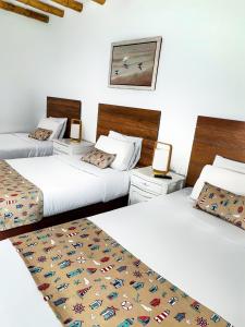 Cama ou camas em um quarto em Atoq Paracas Reserva
