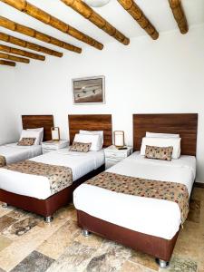 Cama ou camas em um quarto em Atoq Paracas Reserva