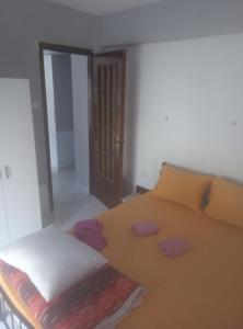 a bedroom with a bed with two pillows on it at Aleksandros Apartments in Paralia Katerinis