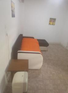 a room with two beds and a table in it at Aleksandros Apartments in Paralia Katerinis