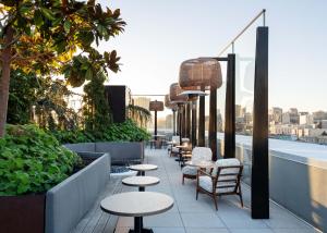 a row of tables and chairs on a rooftop patio at The LINE San Francisco in San Francisco
