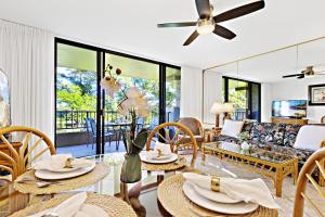 a living room with a couch and tables at Paki Maui 326 in Honokowai