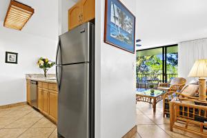 a kitchen with a stainless steel refrigerator in a room at Paki Maui 326 in Kahana