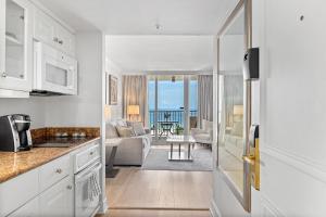 a kitchen and living room with a view of the ocean at Seashells and Sunshine Marco Beach Ocean Resort 1105 in Marco Island