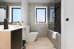 a bathroom with a toilet and a sink and a shower at Cardrona Creekside Apartment in Cardrona