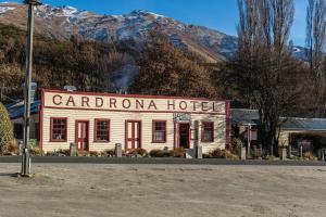 a white building with a sign that reads carron hotel at Cardrona Creekside Apartment in Cardrona