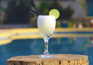 a glass of white drink with a lime slice in it at Nazca Lodge in Nazca