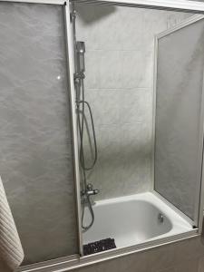 a shower with a glass door in a bathroom at Piso pineda in Monforte de Lemos +10 photos