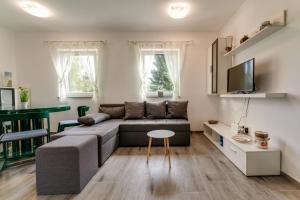 a living room with a couch and a table at Holiday house with a parking space Fuzine, Gorski kotar - 20518 in Lokve