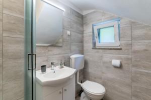 a bathroom with a sink and a toilet and a mirror at Holiday house with a parking space Fuzine, Gorski kotar - 20518 in Lokve +9 photos