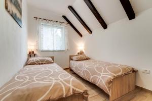 a bedroom with two beds and a window at Holiday house with a parking space Fuzine, Gorski kotar - 20518 in Lokve