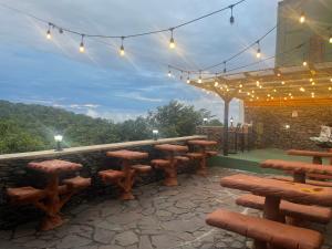 a group of benches and lights on a patio at Cabinas Vista Al Golfo in Monteverde Costa Rica