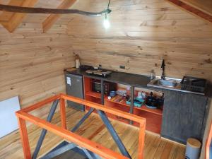 a kitchen with a counter and a sink in a cabin at M Refugios, Termas de Chillán in Pinto