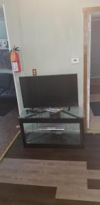 a flat screen tv sitting on a glass table at ARMANI MANOR Rustic UNIT 2 in Wildwood